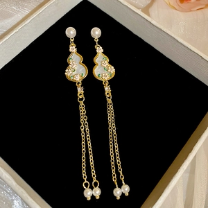 Detail of elegant gourd drop earrings with flower enamel and long pearl tassels