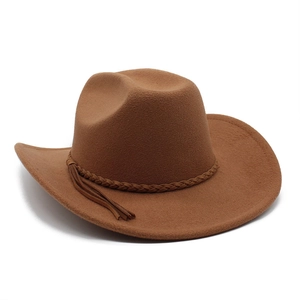 Detail of dark camel wool felt cowboy hat with braided leather band and tassel fringe