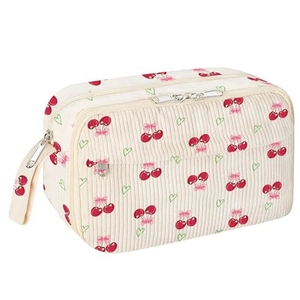 Detail of off-white corduroy pencil case featuring cherry and heart print with zippers