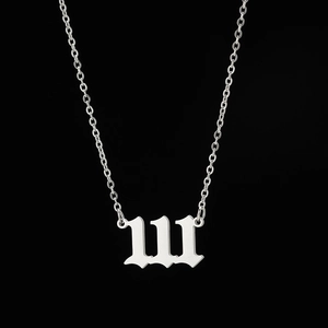 Macro detail of silver gothic number 111 pendant with polished stainless steel chain