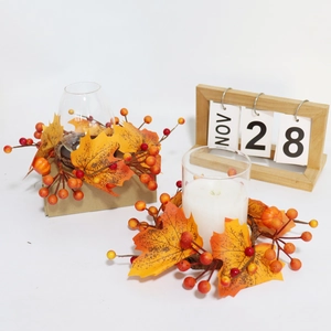 Fall harvest candle ring with maple leaves and pumpkins on a white festive setting