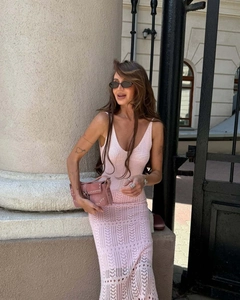 Close-up of pink crochet knit dress featuring intricate hollow patterns and slim fit