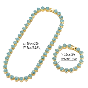Macro detail of 10mm gold Cuban link set with blue rhinestones and size measurements