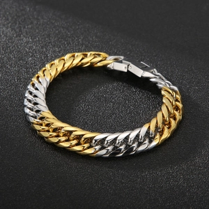 Detail of two-tone gold and silver cuban link bracelet with polished metal clasp