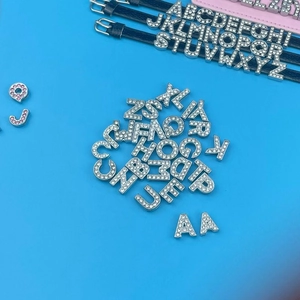 Detail showing crystal rhinestone alphabet sliders for DIY leather bracelet accessories