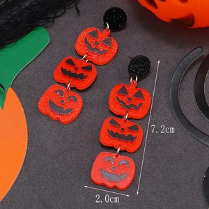 Detail view of acrylic Halloween pumpkin earrings with three-layer stacked design and sizes