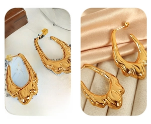 Detailed macro view of 18K gold plated hollow earrings with irregular lava texture