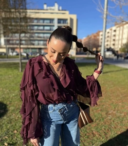 Detailed ruffled layered dark purple chiffon shirt paired with high waist blue jeans