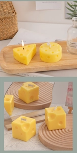 Detailed close-up of cheese-shaped scented candles on a wooden tray with a mirror