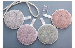 Detailed top view of four plush bamboo fiber makeup remover pads in multiple colors