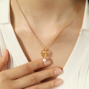 Elegant angel wings holding a white pearl pendant necklace in gold finish for women
