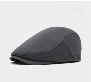 Detail of light gray flat cap featuring breathable mesh fabric and a metal side buckle