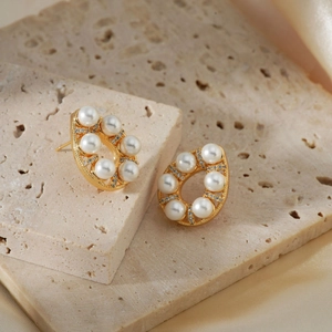 Elegant gold teardrop earrings with white pearls and sparkling cubic zirconia stones