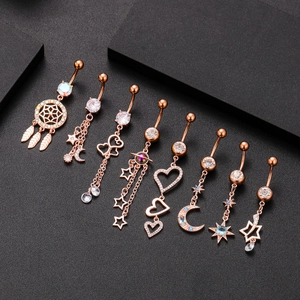 Rose gold navel rings with dreamcatcher, moon and star charms set with cubic zirconia