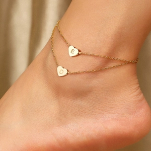 Double-layered gold heart anklet with engraved letters E and D on heart pendants