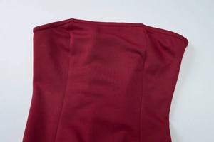 Close-up detail of burgundy tube top dress showing fine stitching and knit fabric texture