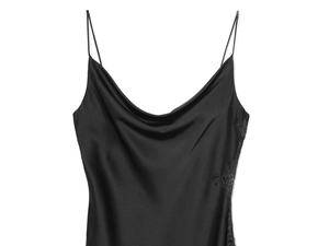 Detail of elegant black satin slip dress showing delicate lace trim and silky texture