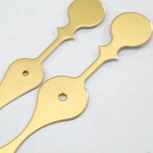 Golden vintage spade style metal clock hands with brushed finish on white background