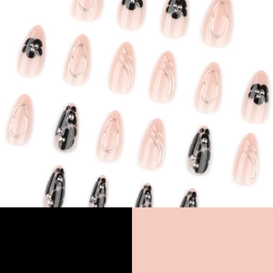 Short almond press-on nails with black flower petals, marble patterns and silver studs
