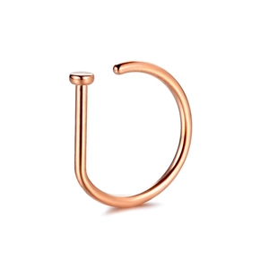 Macro view of a polished D-shaped rose gold nose ring made of high-quality stainless steel