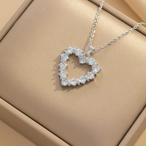 Elegant silver heart pendant necklace with clear zircons in a beige jewelry gift box