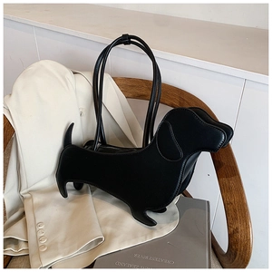 Chic black dachshund-shaped leather crossbody bag displayed on a stylish blazer