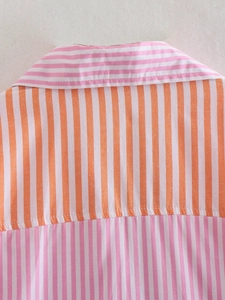 Close-up of orange and pink striped shirt showing stitching detail and cotton fabric texture
