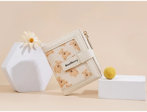 Close-up of beige wallet featuring cute cartoon bear prints and textured cross-grain leather
