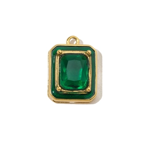 Detailed macro view of an emerald green gemstone pendant with a gold vintage metal frame
