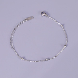 Minimalist silver bead bracelet with lobster clasp and adjustable chain on purple background