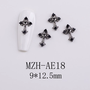 Close-up of gunmetal gothic cross nail charms with black rhinestones for nail art