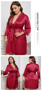 Detailed view of the red satin robe's elegant lace trim on the V-neck and sleeve cuffs