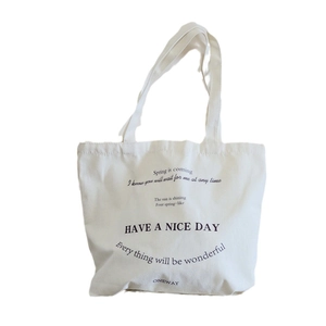 Cream canvas tote bag with minimalist black text print shown on a plain white background