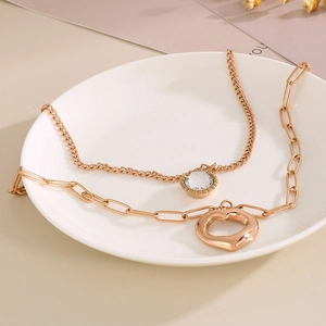 Collana a doppio strato in acciaio dorato con pendente a cuore e ciondolo di cristallo