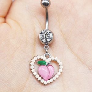 Macro detail of silver navel ring with crystal stud and pearl heart peach pendant