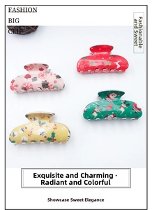 Detailed view of PVC Christmas hair claws with festive reindeer and Santa prints