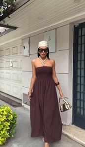 Detail of a dark brown strapless maxi dress with smocked waist and golden starfish necklace