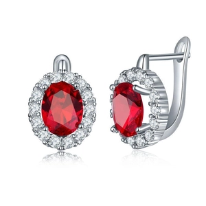 Detail view of silver lever-back earrings with oval red gemstone and pavé CZ halo