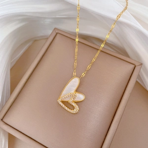 Detail of double heart necklace with mother of pearl and sparkling crystals on silk