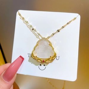 Detailed macro of gold-plated necklace featuring a jade Buddha pendant with zircons