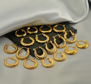 Macro view of assorted 18K gold plated stainless steel hoop earrings with textured finishes