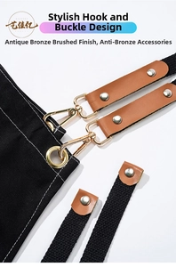 Detail of bronze metal hook and rivet on black canvas apron with brown leather strap