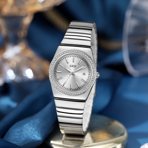 Luxury silver ladies quartz watch with diamond bezel and calendar on dark blue silk