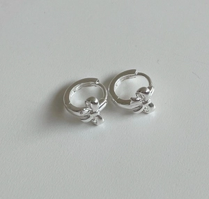 Detailed view of 925 sterling silver bow earrings with a polished metallic finish