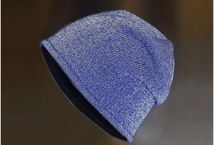 Detail of blue and white knit beanie showing mixed yarn texture and warm black lining