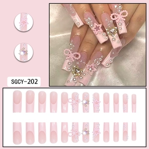Pink press-on nails with pearls, bow accents, and heart rhinestones in a SGCY-202 set