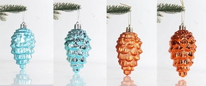Detail of pine cone Christmas ornaments in blue, teal, orange, and bronze electroplated finishes