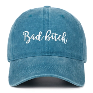 Close-up of vintage blue washed denim baseball cap with white Bad Bitch embroidery detail