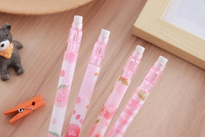 Close-up of pink peach-patterned mechanical eraser pen with white core on wood