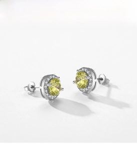 Detailed macro of S925 silver halo stud earrings with round yellow gemstone